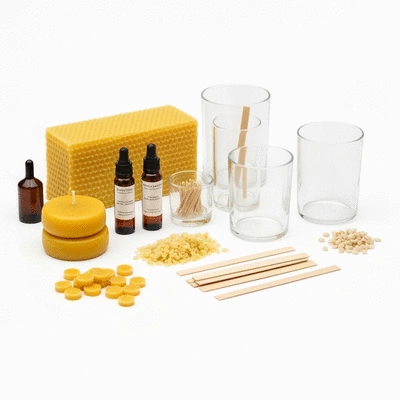 A beautifully arranged DIY candle making kit with various components on a clean white background