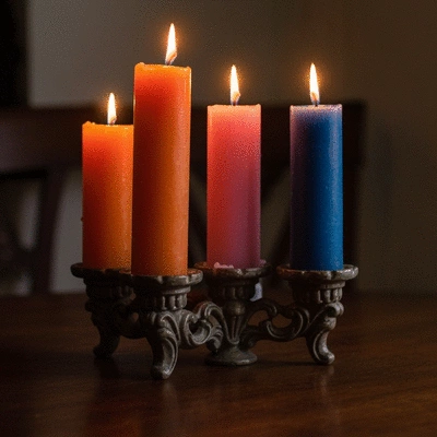 Various candle making supplies neatly arranged on a clean wooden table